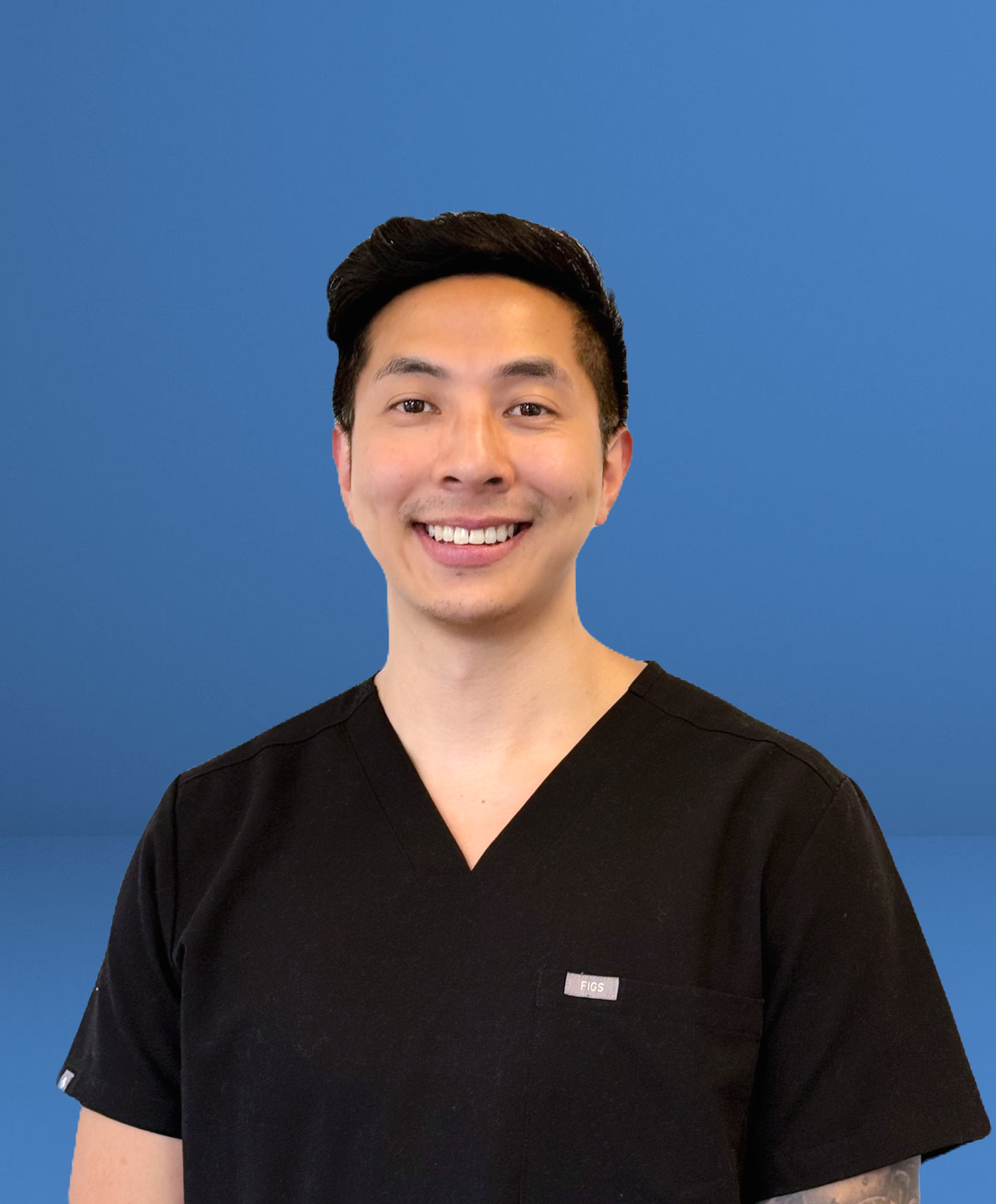 Encore chiropractor in black scrubs