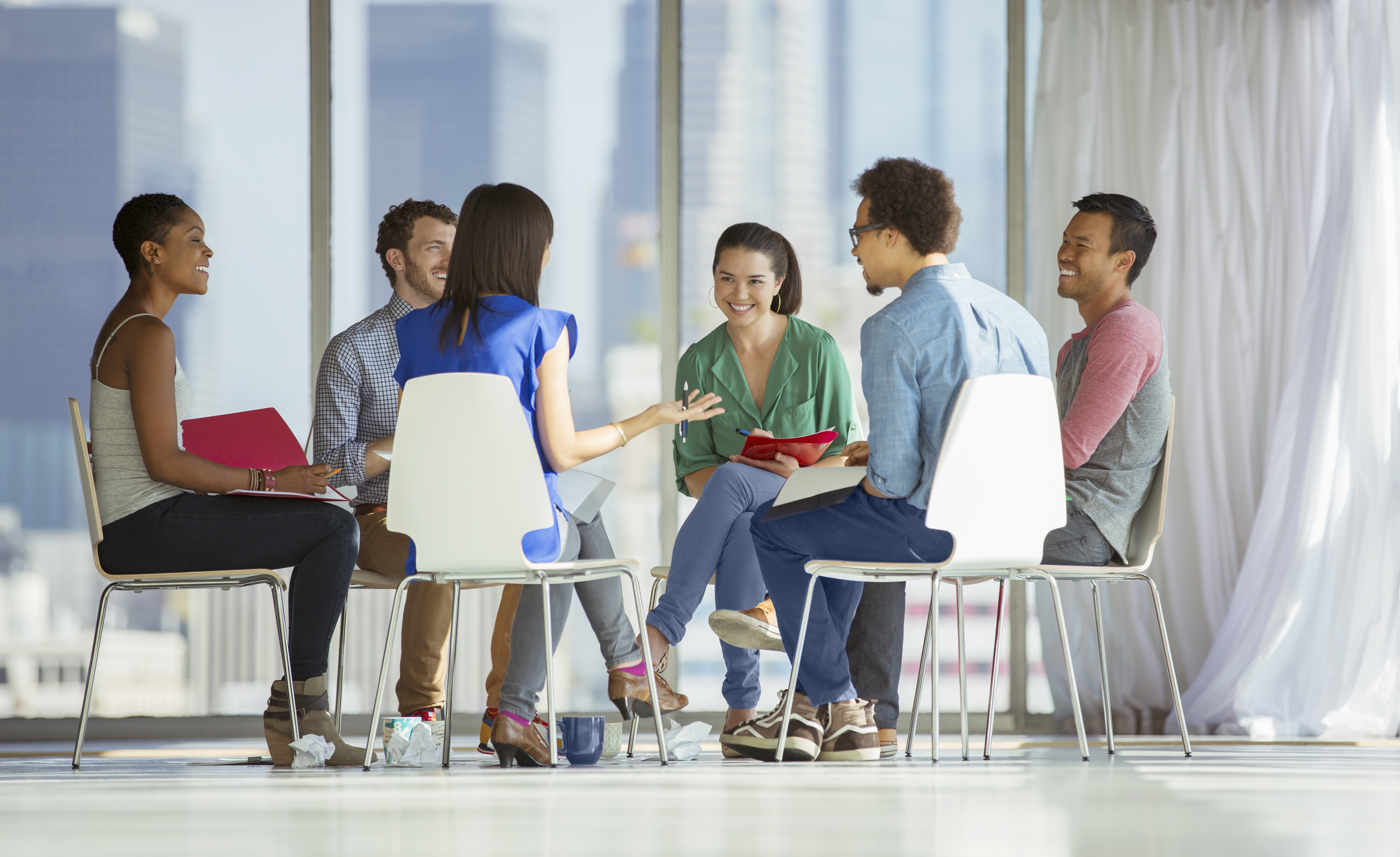 A group of professionals in a circle during a group coaching session
