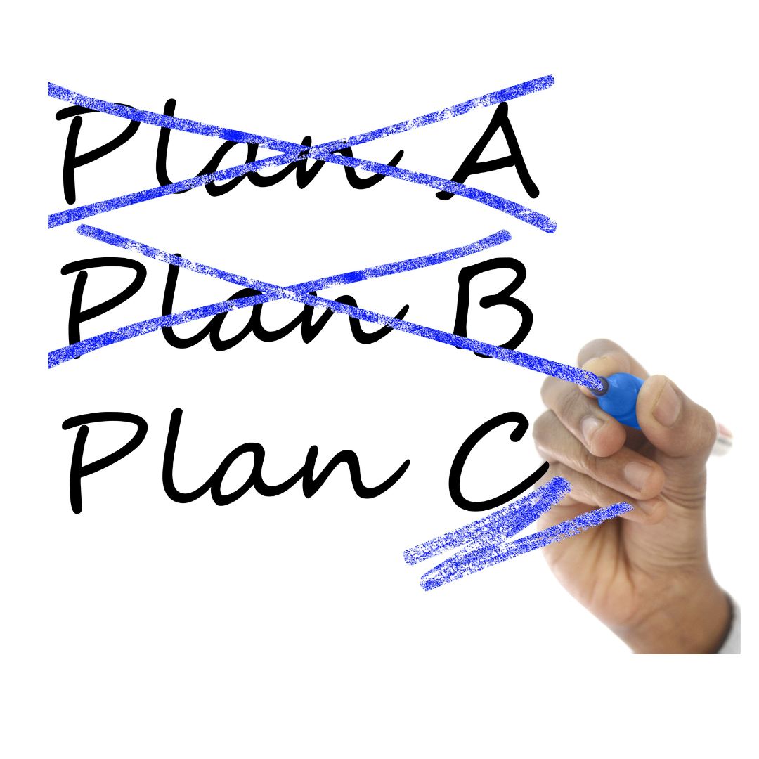 Hand crossing out Plan A and Plan B with a blue marker