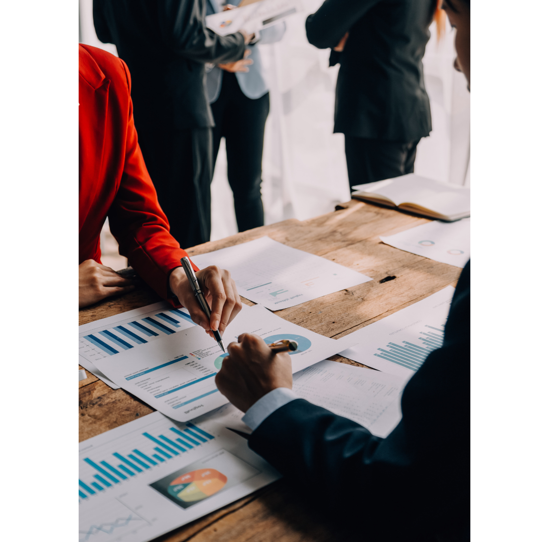 Business team reviewing charts and reports across a table