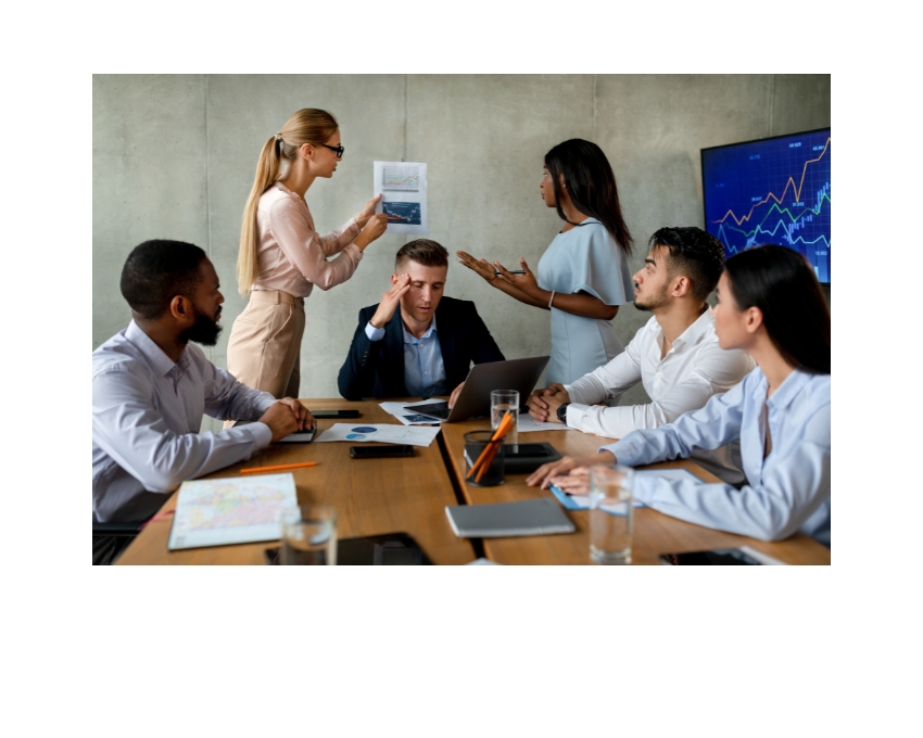 Manager overwhelmed while team members argue around him