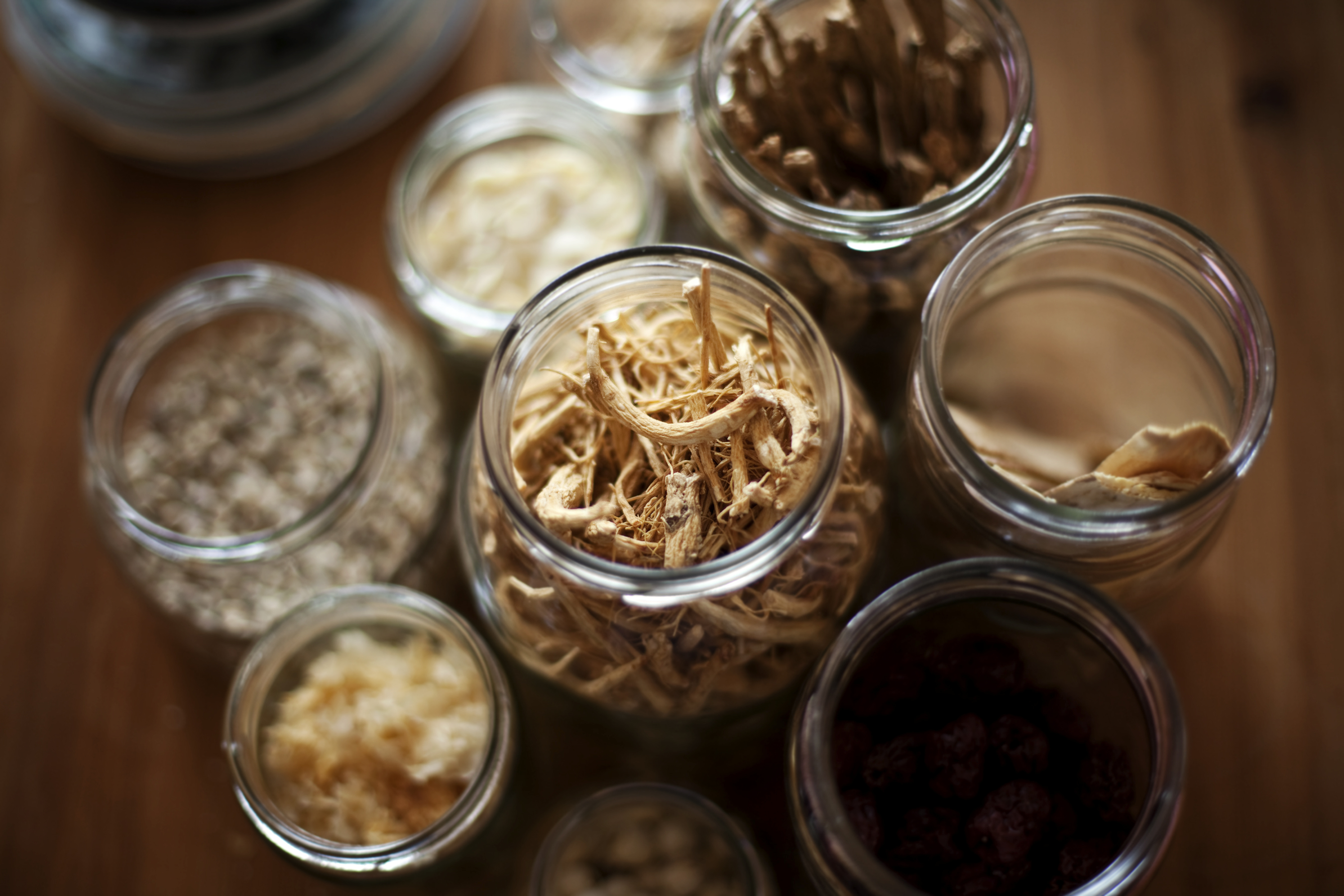 Jars of dried Chinese herbs used to prepare a herbal medicine formula
