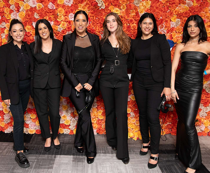The six women of the EventPros LA team posing in front of a colorful floral wall