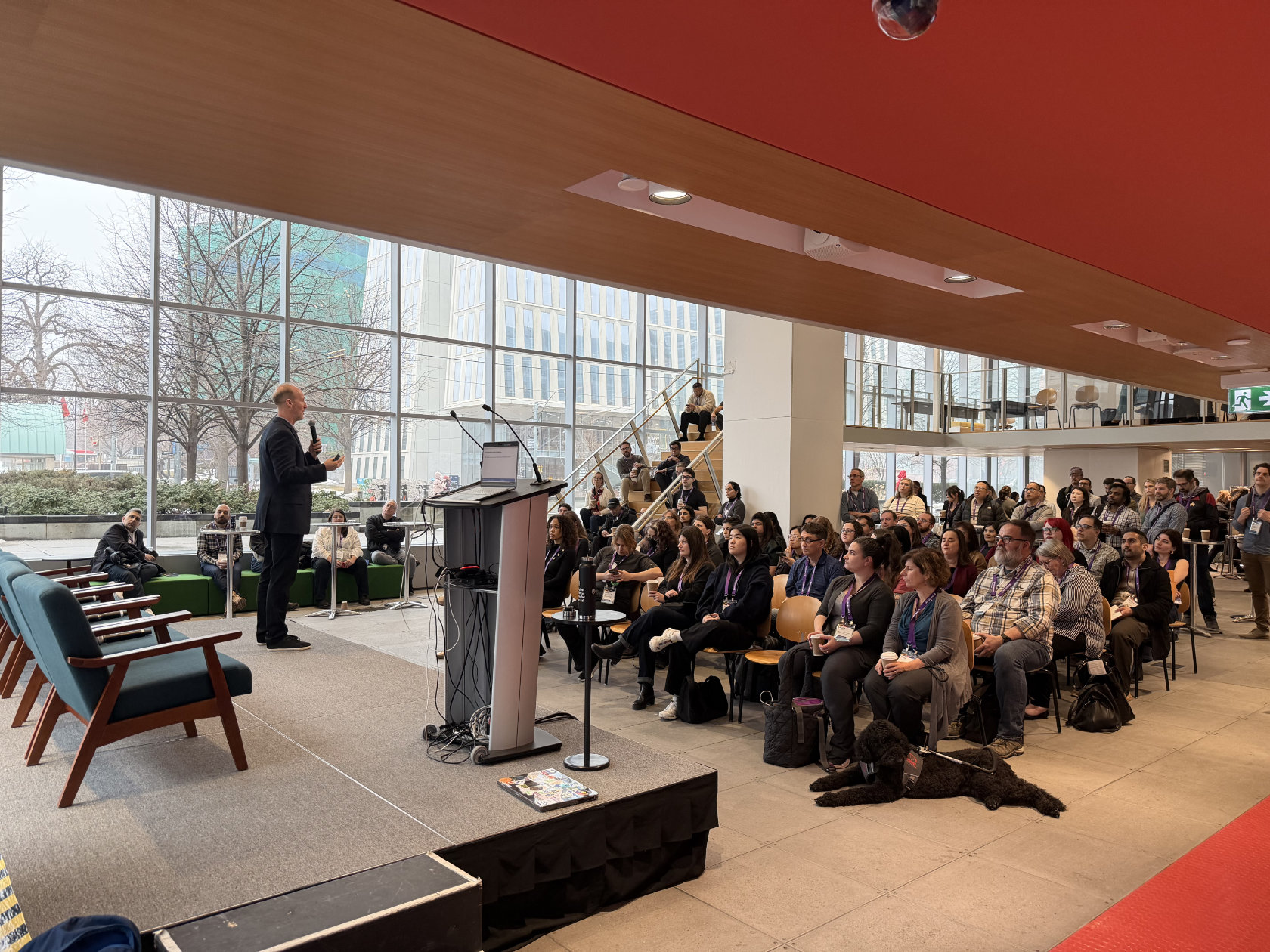 Closing keynote speaker addressing a large seated audience at EvolveDigital Toronto 2026