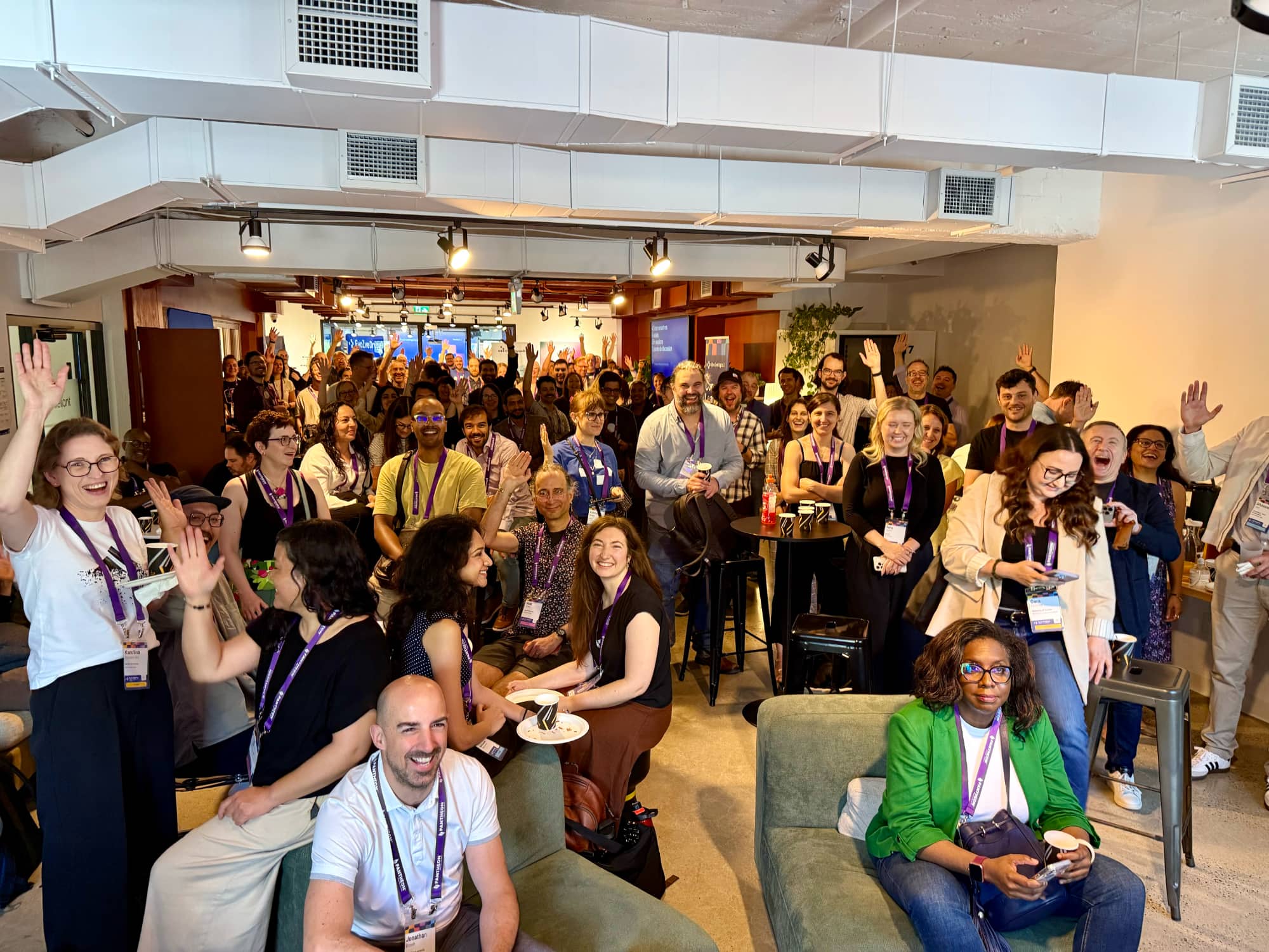 EvolveDigital attendees with purple lanyards cheering in a co-working space in Montreal