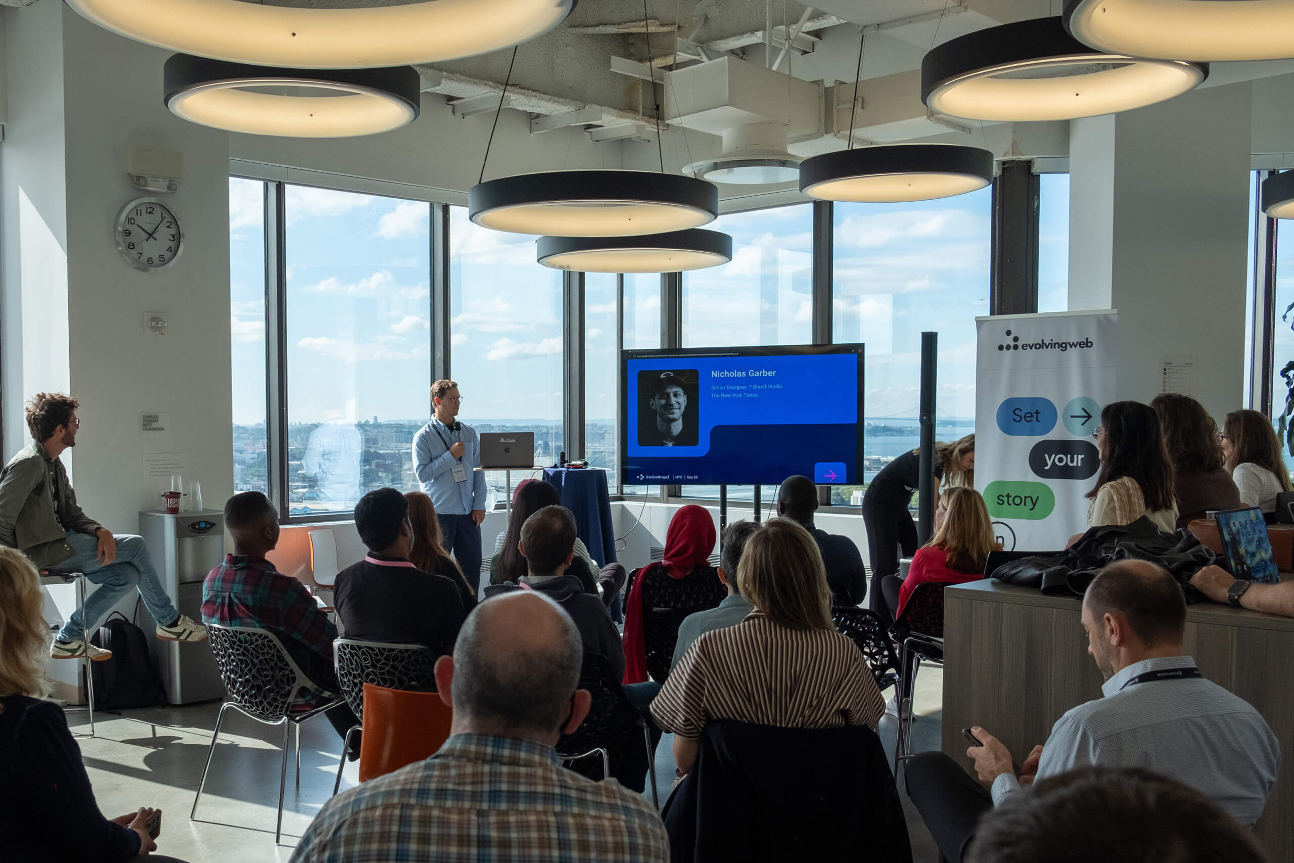 Speaker presenting to a large seated audience at EvolveDigital NYC