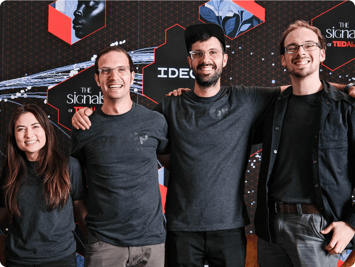 The four-person Eyes Up crew in branded shirts at a TEDAIx event.