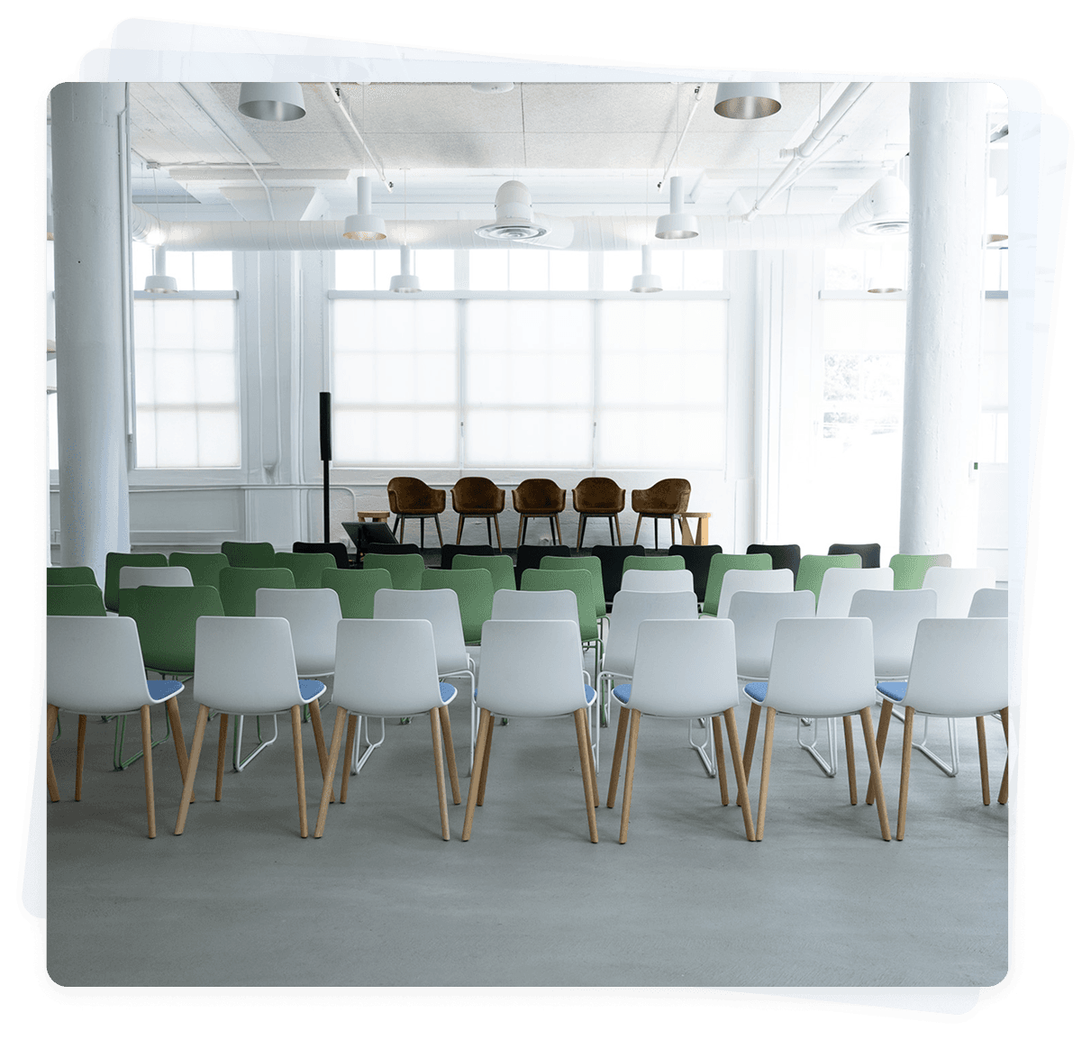 Small San Francisco venue set with rows of chairs facing a stage before an event.