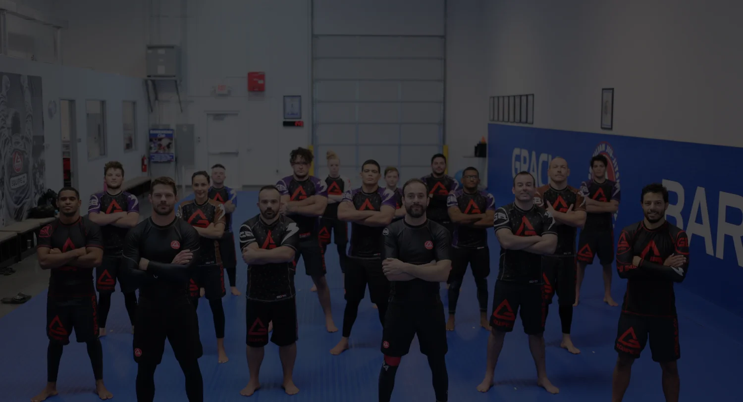 Gracie Barra Studio City students and coaches in gis gathered on the blue mat during class