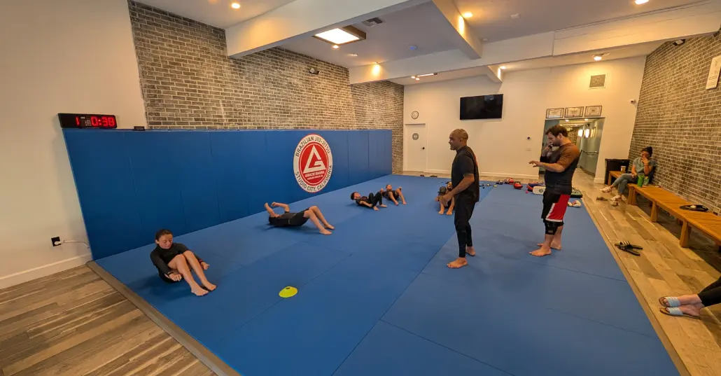 Wide interior view of the Studio City mat area with students training
