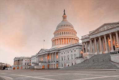 The United States Capitol at dusk in warm golden light