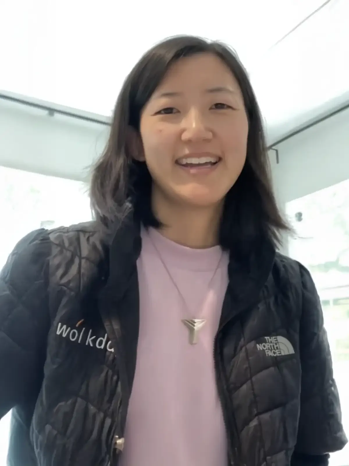Dasol Jung, smiling young woman in a vest indoors