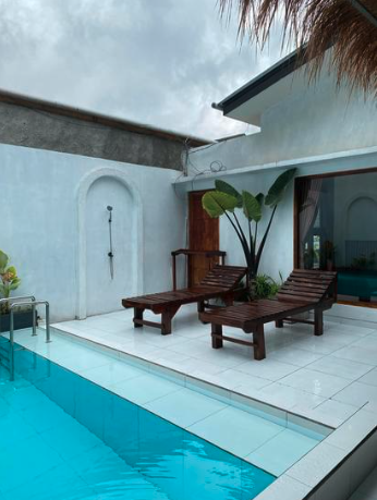 Private pool area with lounge chairs at a retreat villa