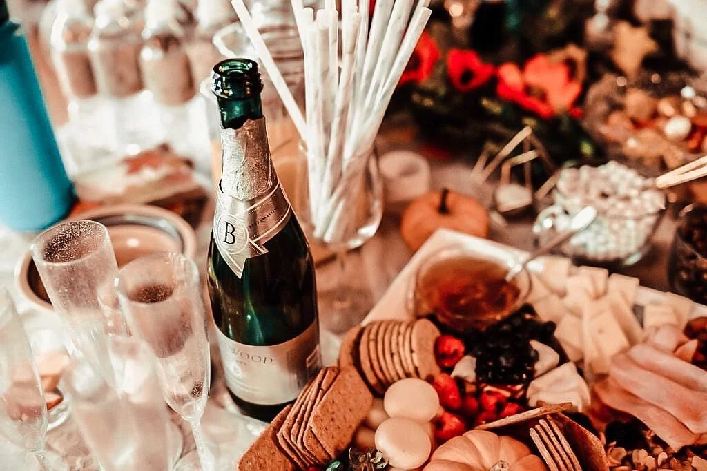 Champagne with flutes beside a dessert and candy grazing board