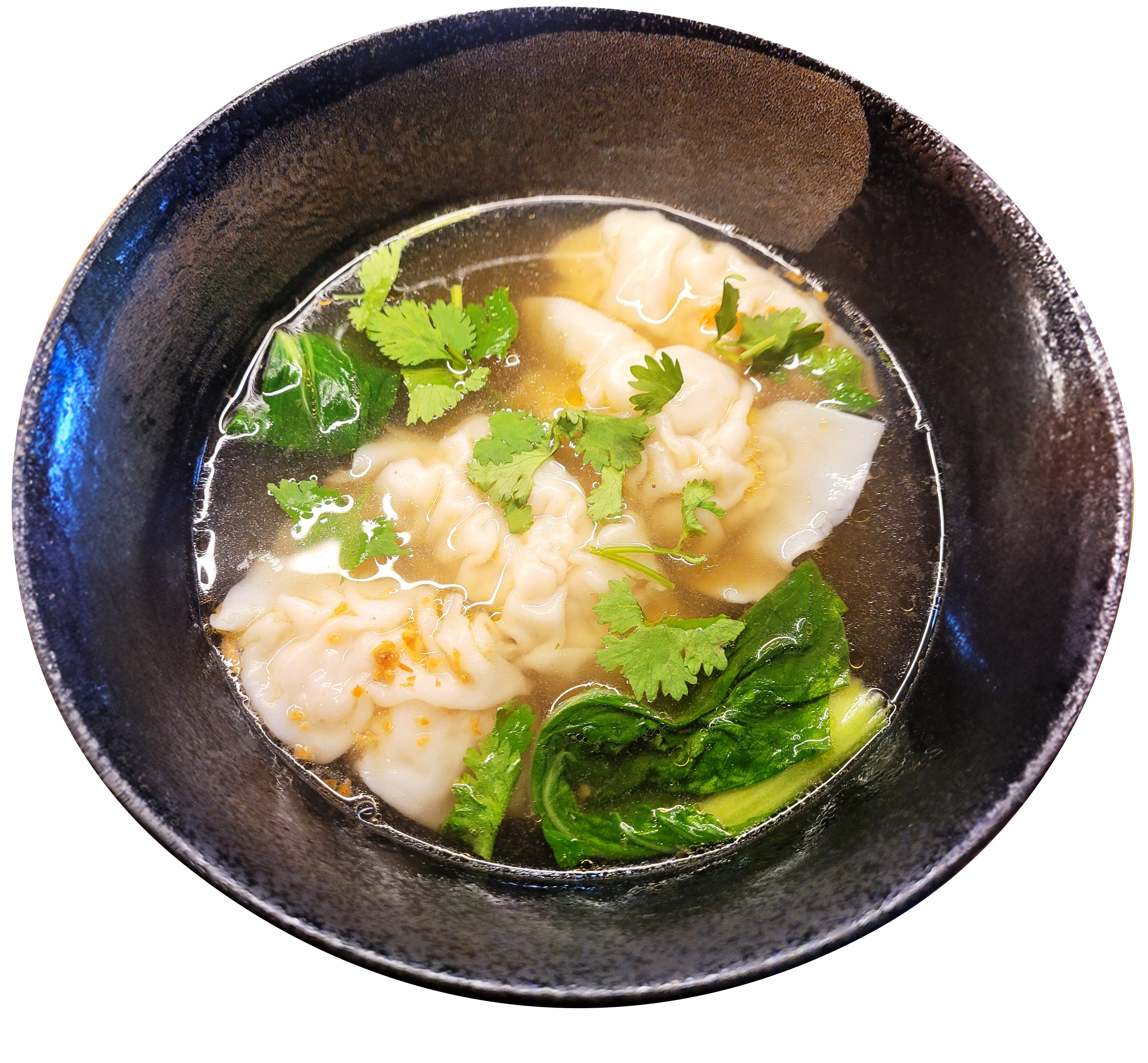 Wonton soup with bok choy and cilantro in a dark ceramic bowl