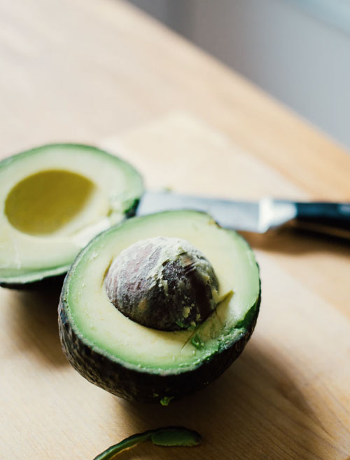 Sliced avocado on a cutting board representing nutrition
