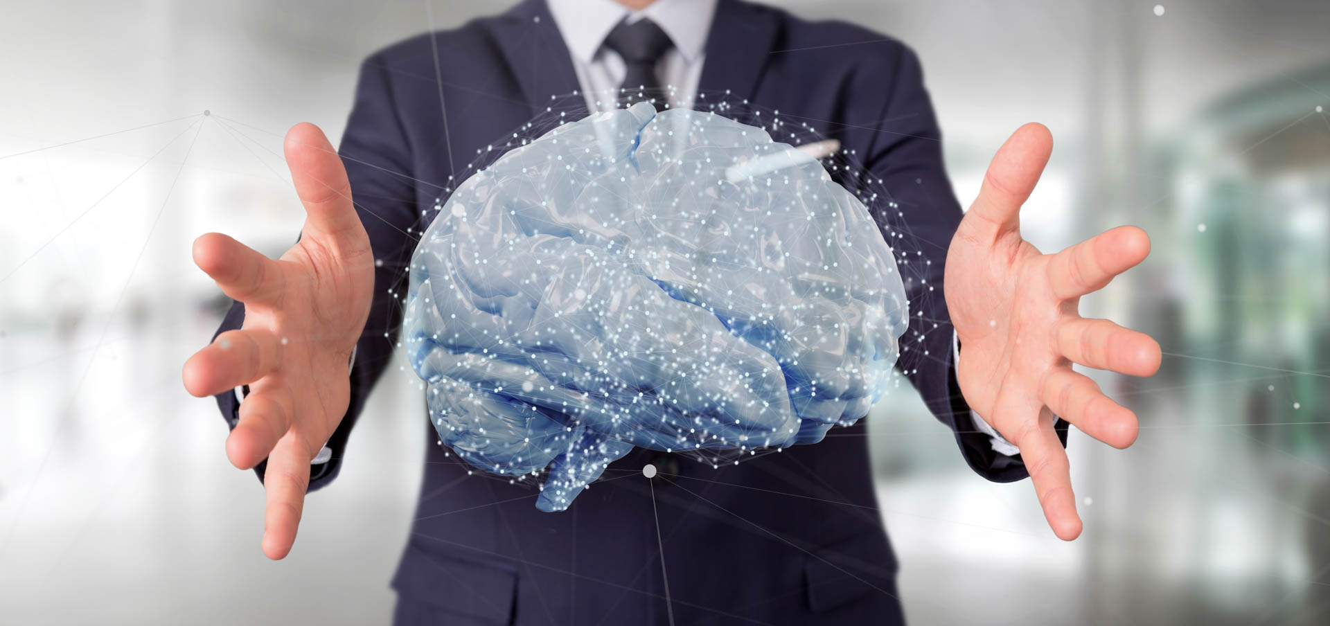 Businessman presenting a glowing holographic brain with network nodes