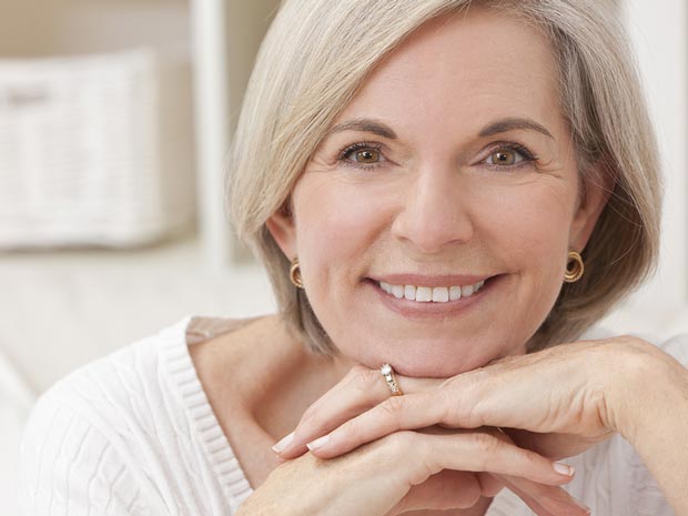 Smiling woman resting her chin on her hands