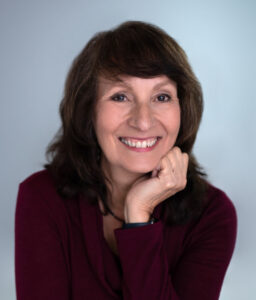 Victoria Lynne Hannu, smiling with hand near chin