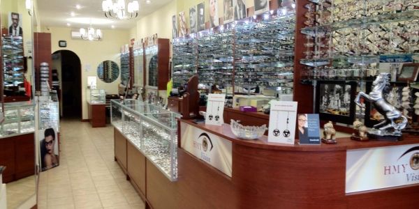 Inside HMY Vision's Upper East Side store: reception desk and eyewear display cases