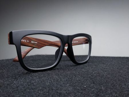 Close-up of black and wood-grain designer eyeglass frames