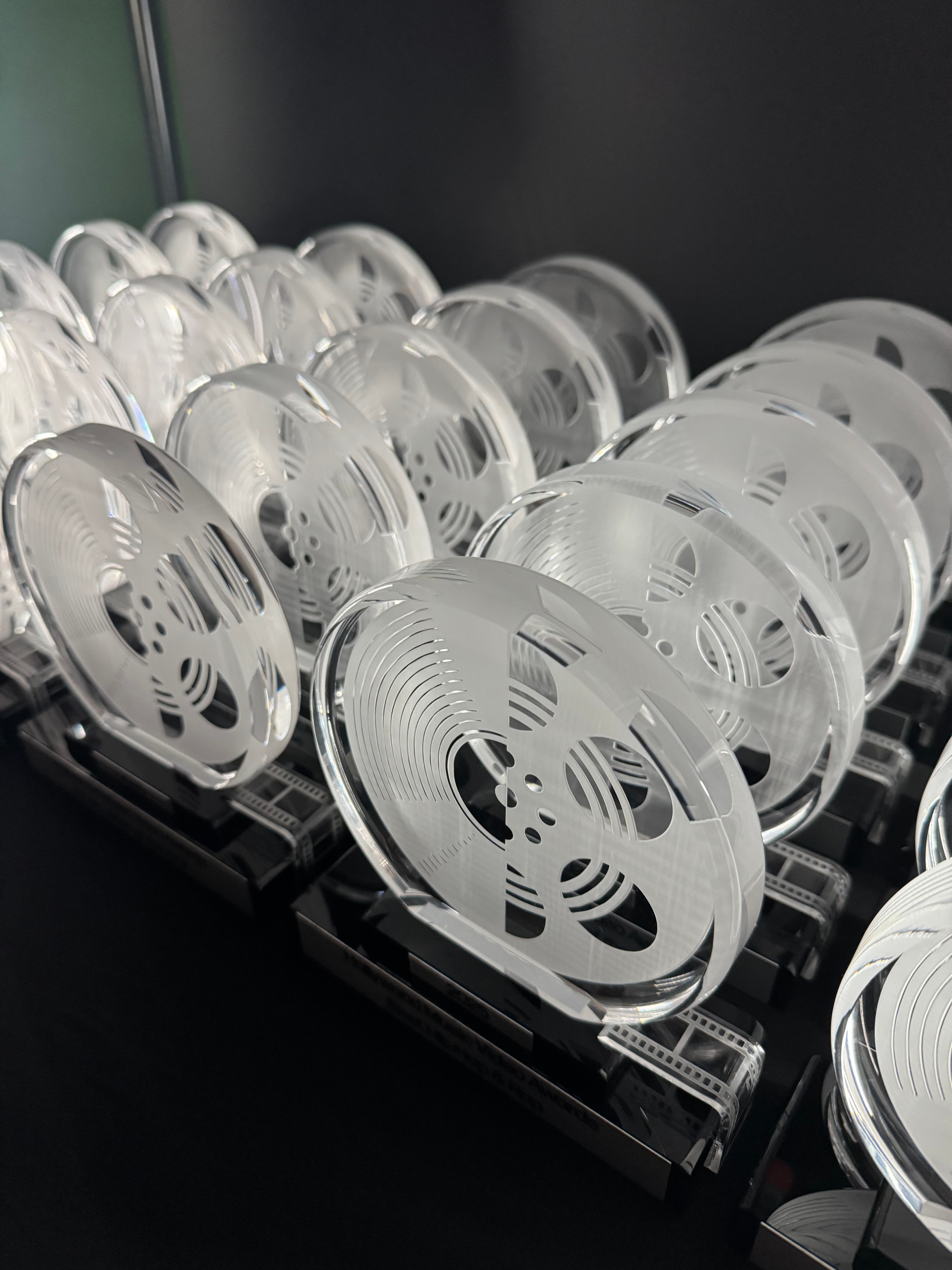 Crystal film reel trophy awards on black stands