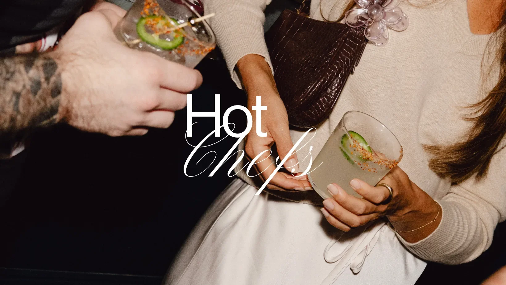 Two guests holding chili-rimmed cocktails at a Hot Chefs hospitality event.