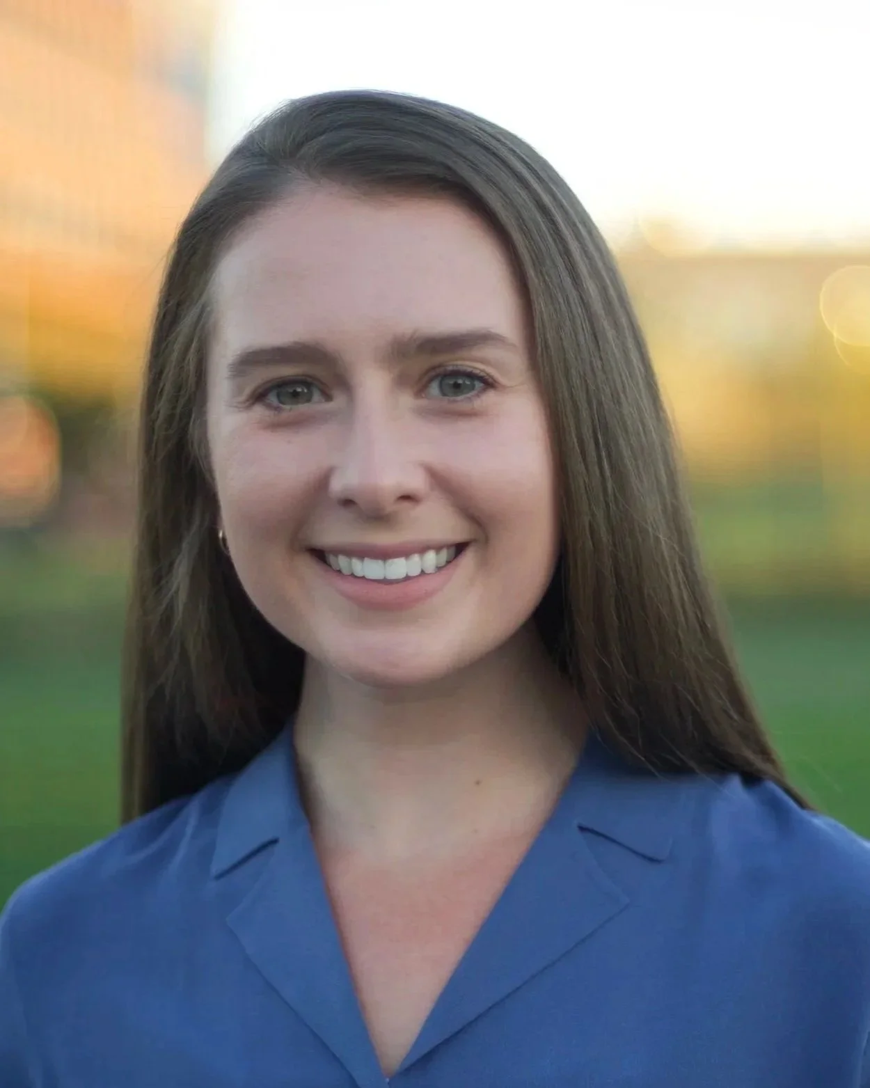 Megan Edwards, PT, DPT — outdoor headshot in a blue lapel top