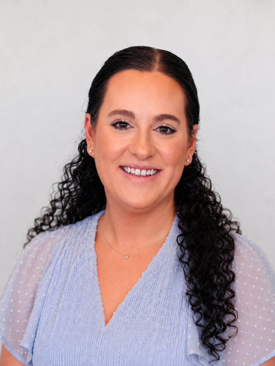 Hannah Lowden — headshot in a light blue blouse