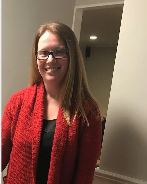 Julie Bulson — portrait with glasses and a red cardigan