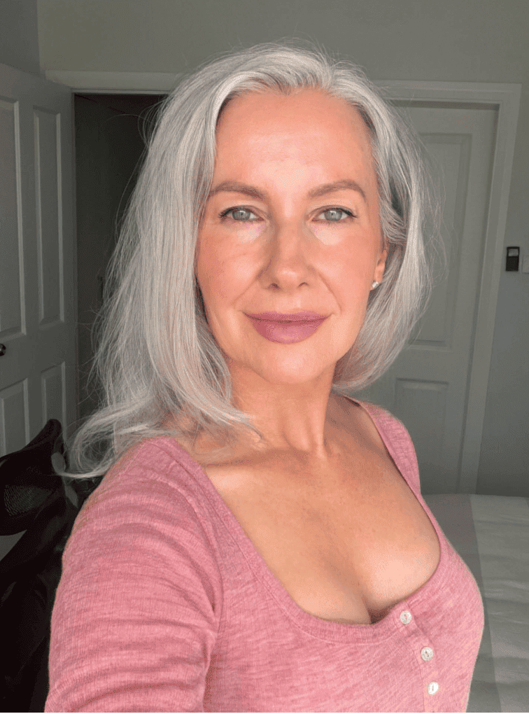 Eve, the matchmaker — a woman with long silver-grey hair in a pink top