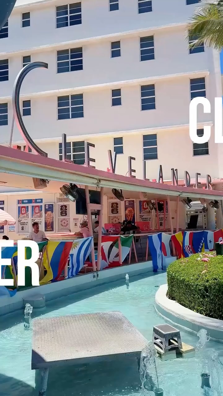 Pool bar area at The Clevelander hotel in South Beach decorated with international flags