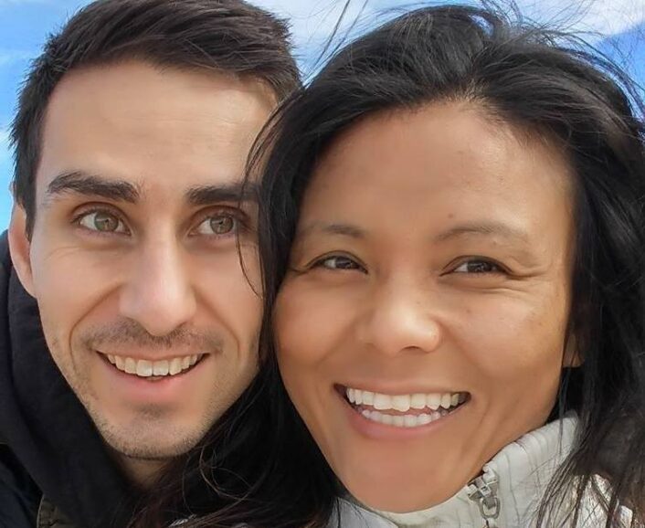 Brett Engle and Penpa Dolma smiling together outdoors, the co-founders of Innovative Yogis