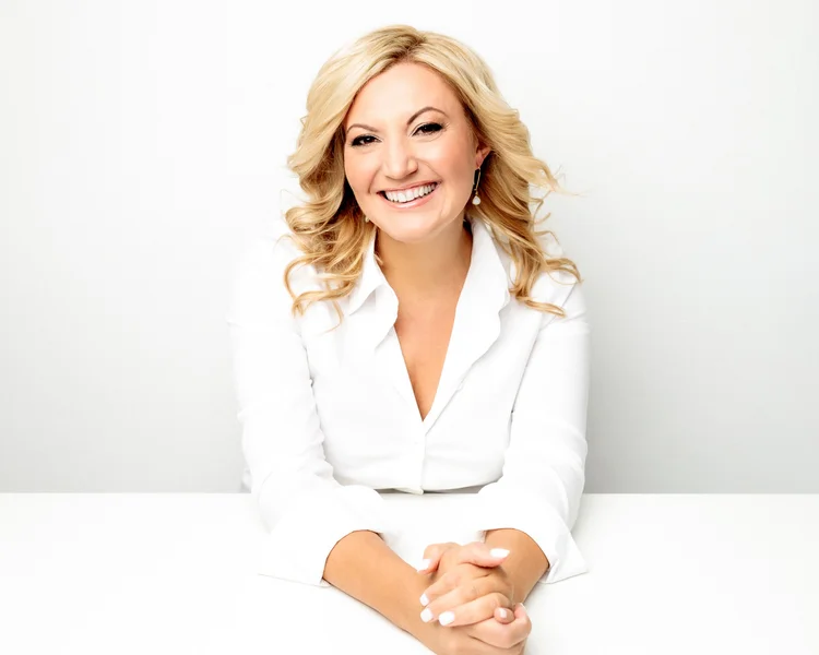Melissa Severance, smiling in a white blazer