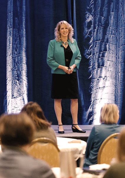 Michelle Steffes on stage delivering a keynote, closer view