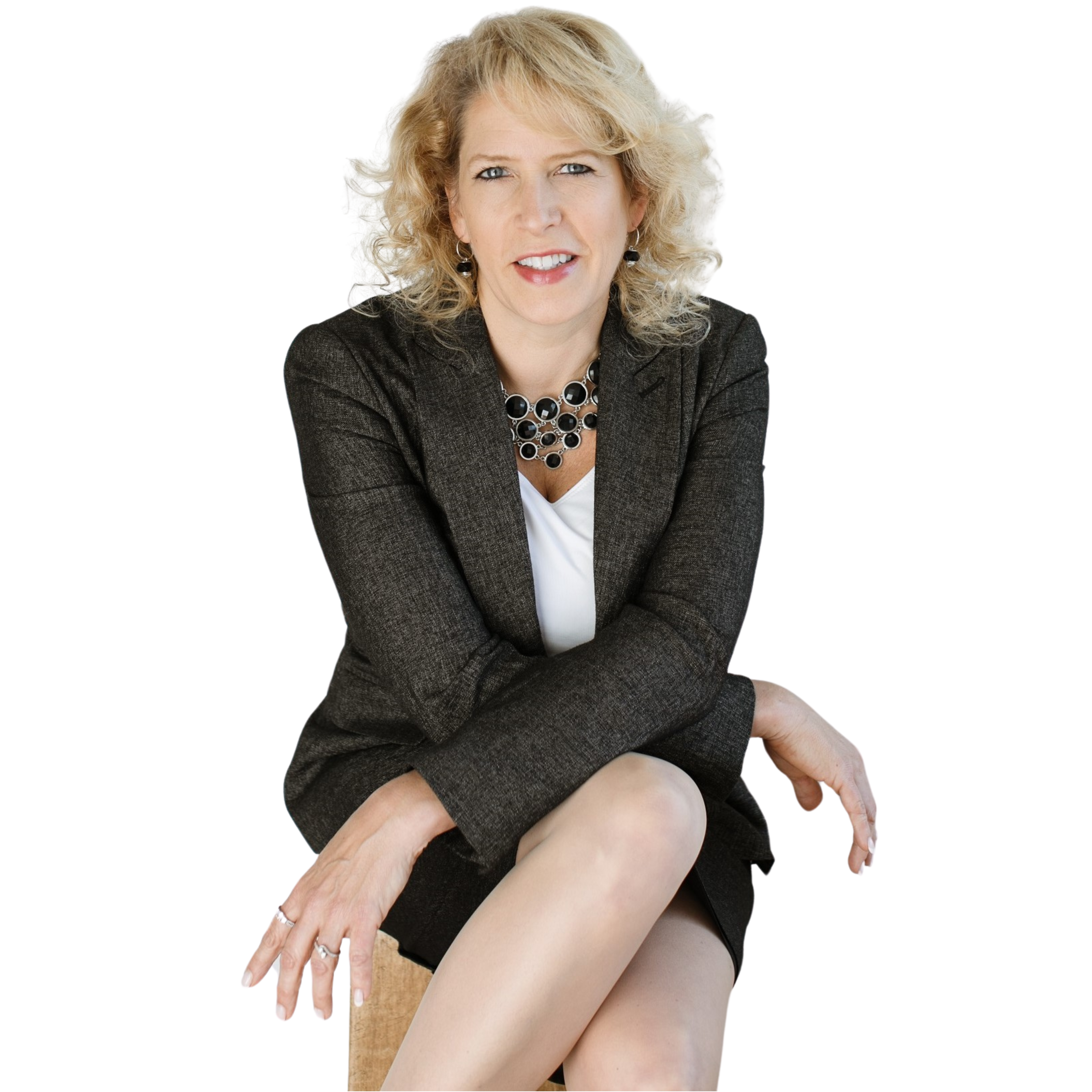 Michelle Steffes, keynote speaker and performance coach, seated in a dark blazer