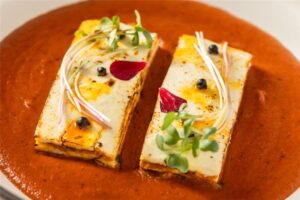 Paneer Laung Latta layered with nuts in lababdar gravy