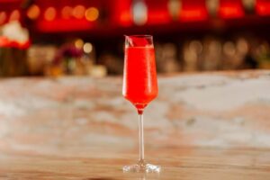 Red cocktail in a coupe glass at the Ishq bar