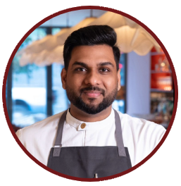 Portrait of Chef Vamshi Adi in his kitchen apron
