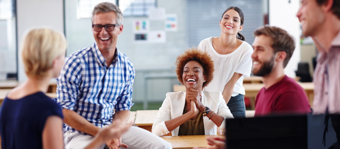 Diverse smiling colleagues around a table