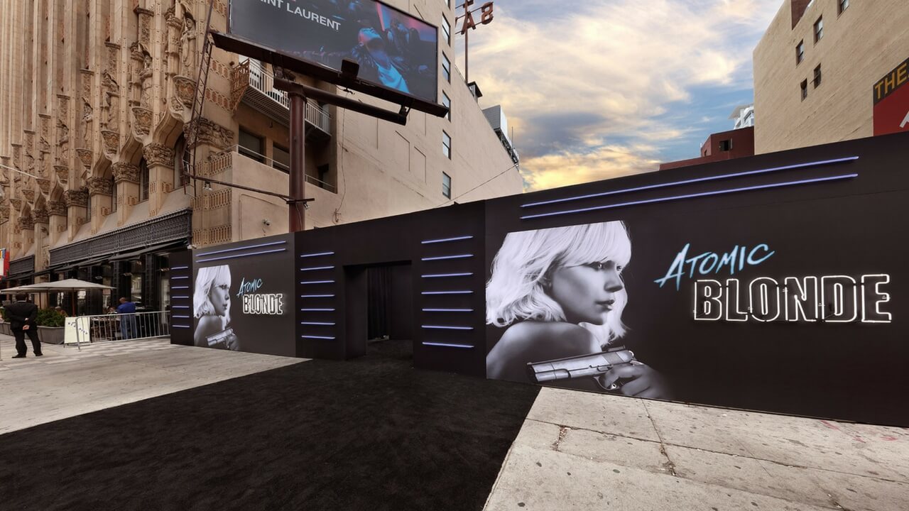 Outdoor red carpet premiere setup for Atomic Blonde with large branded wall panels