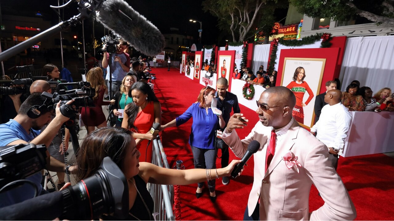 Almost Christmas movie premiere red carpet with press line and cameras