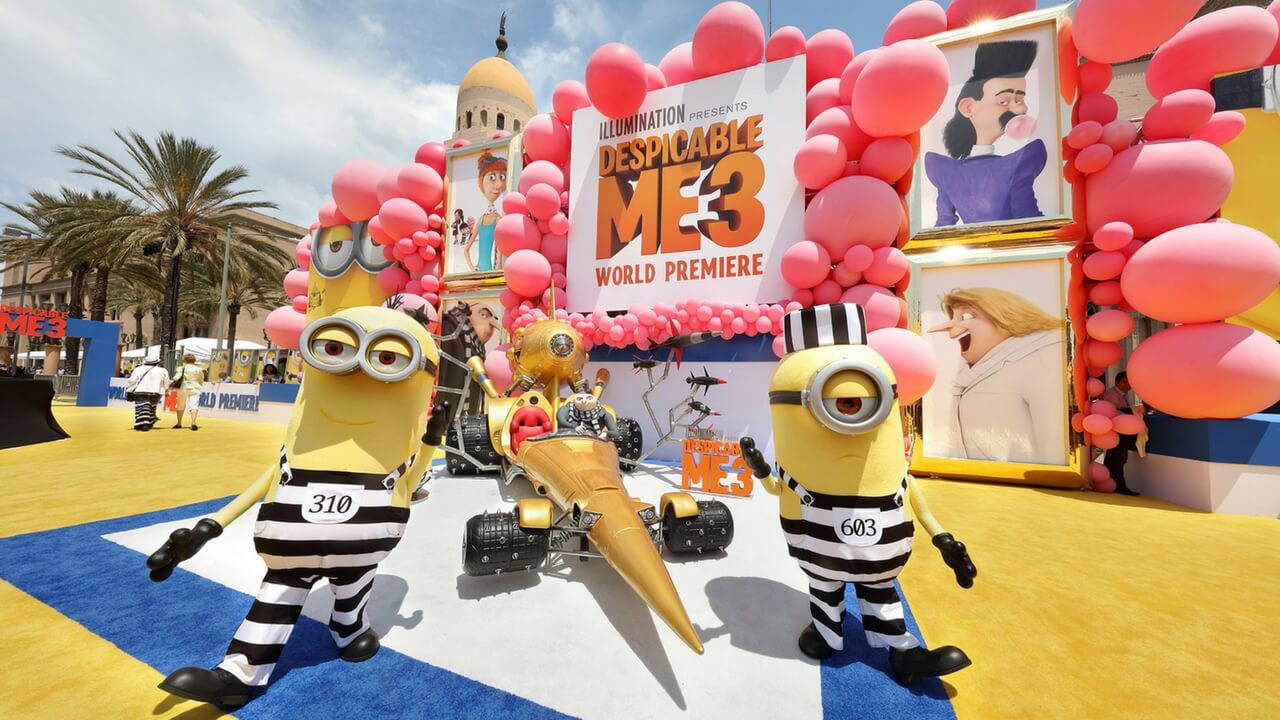Despicable Me 3 world premiere with Minion costumes, balloon arch, and branded signage