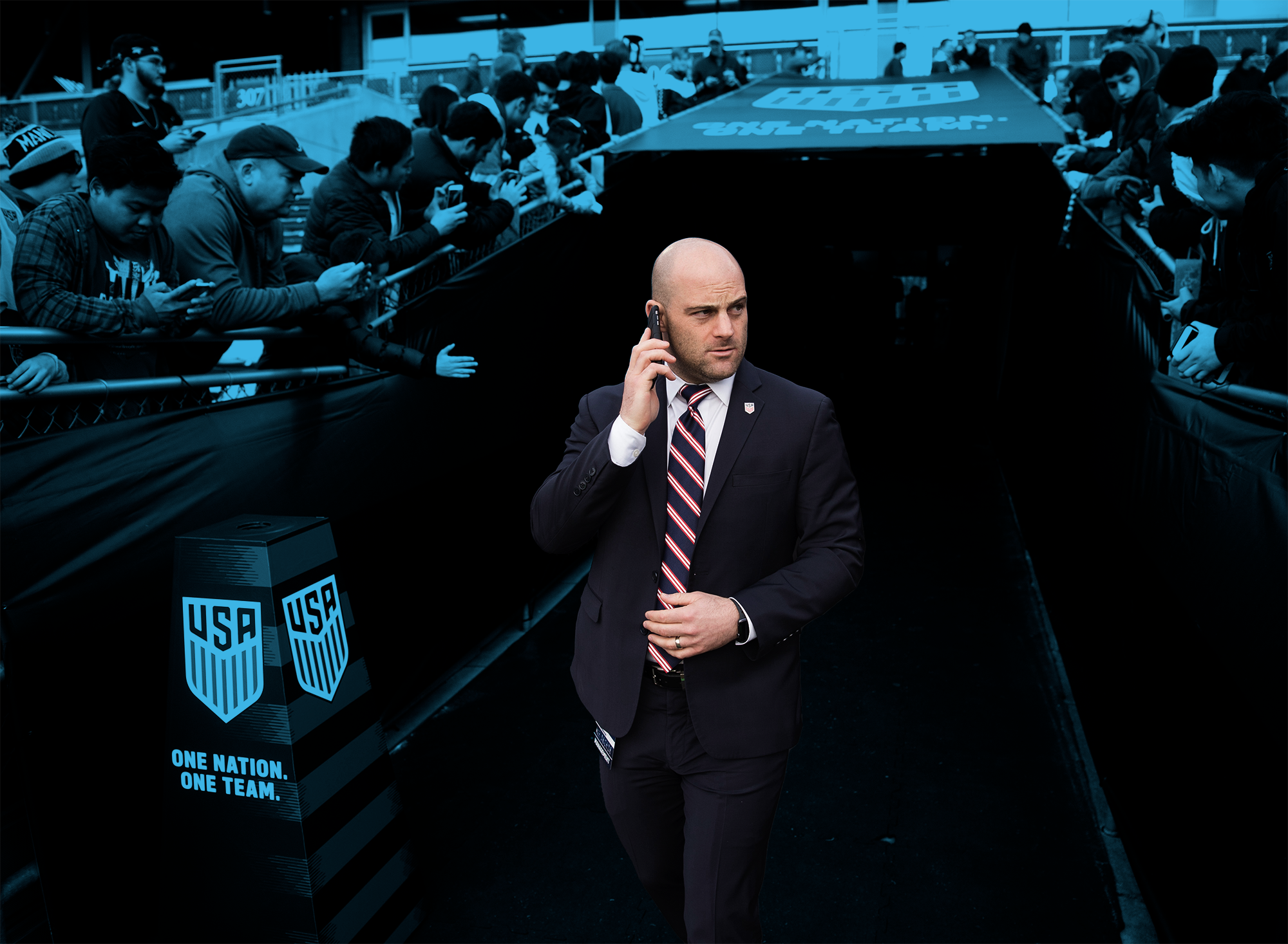 Jon Fleishman in a suit on the phone in a press room