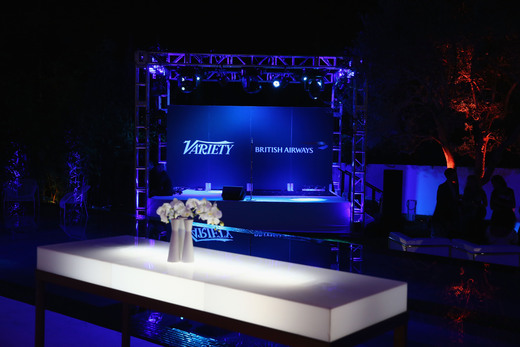 Nighttime branded stage with Variety and British Airways signage in blue lighting