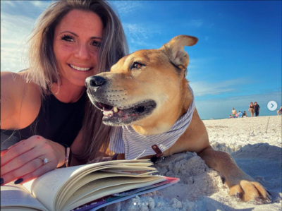 Bethany O'Connor with a dog on the beach