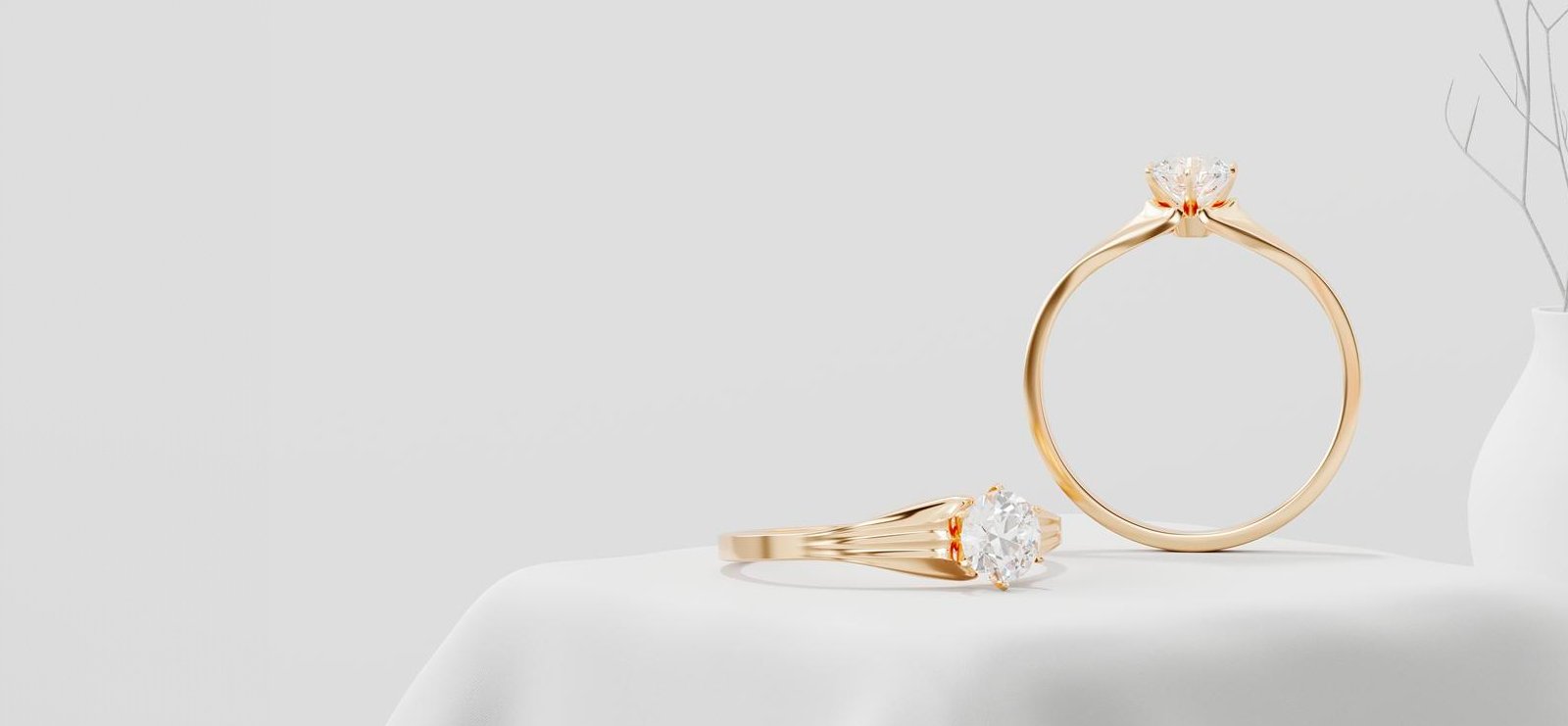 Two gold solitaire diamond engagement rings