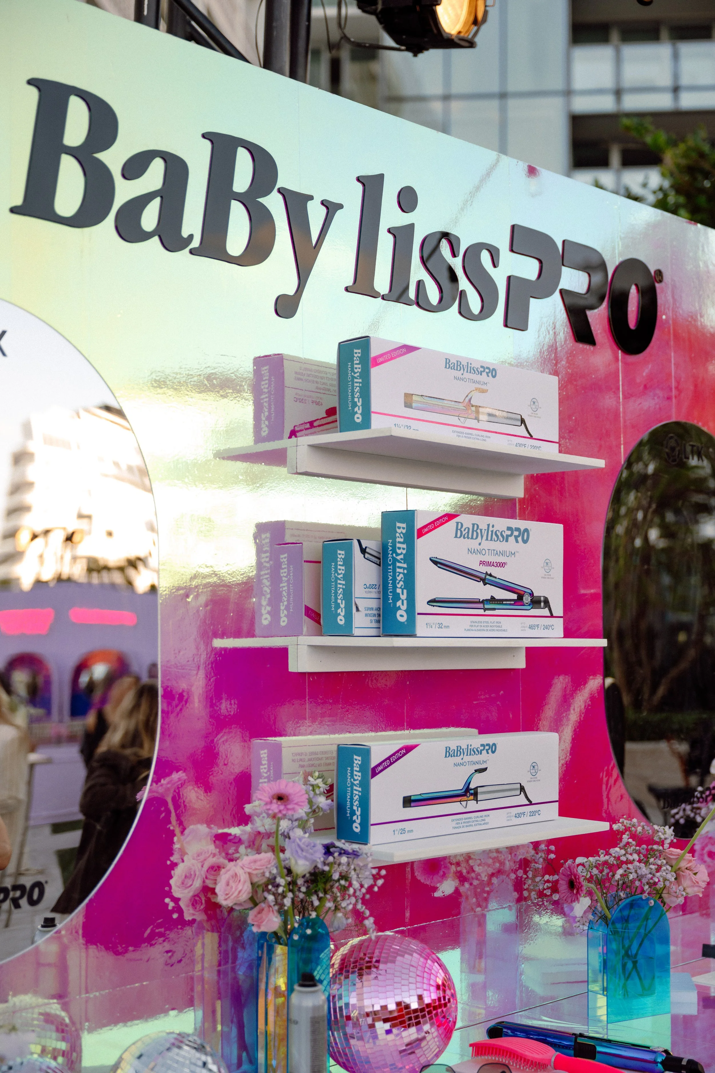 BaBylissPRO styling tool display on a pink iridescent backdrop