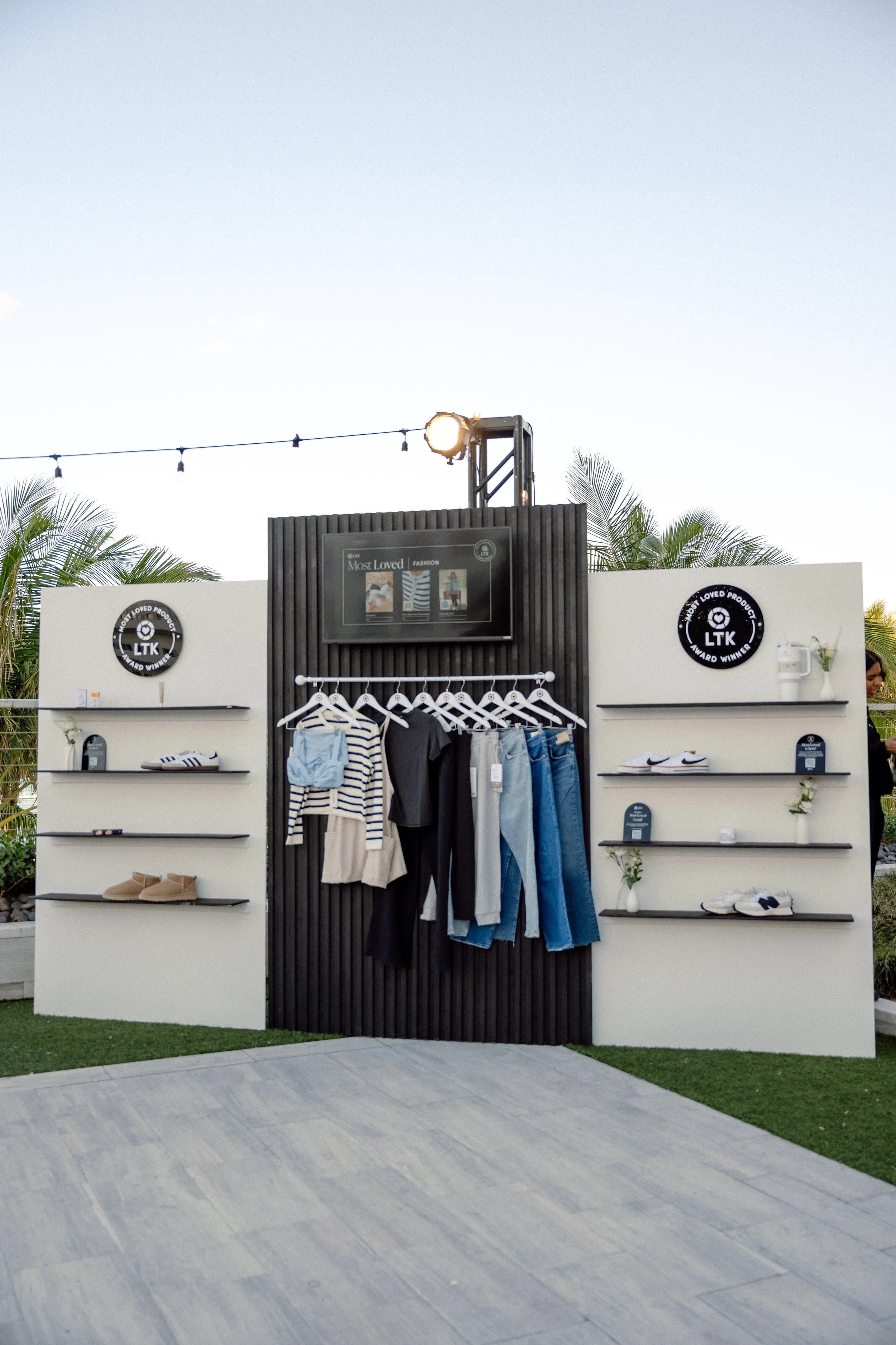 LTK Most Loved Fashion display wall with clothing rack and shelved footwear