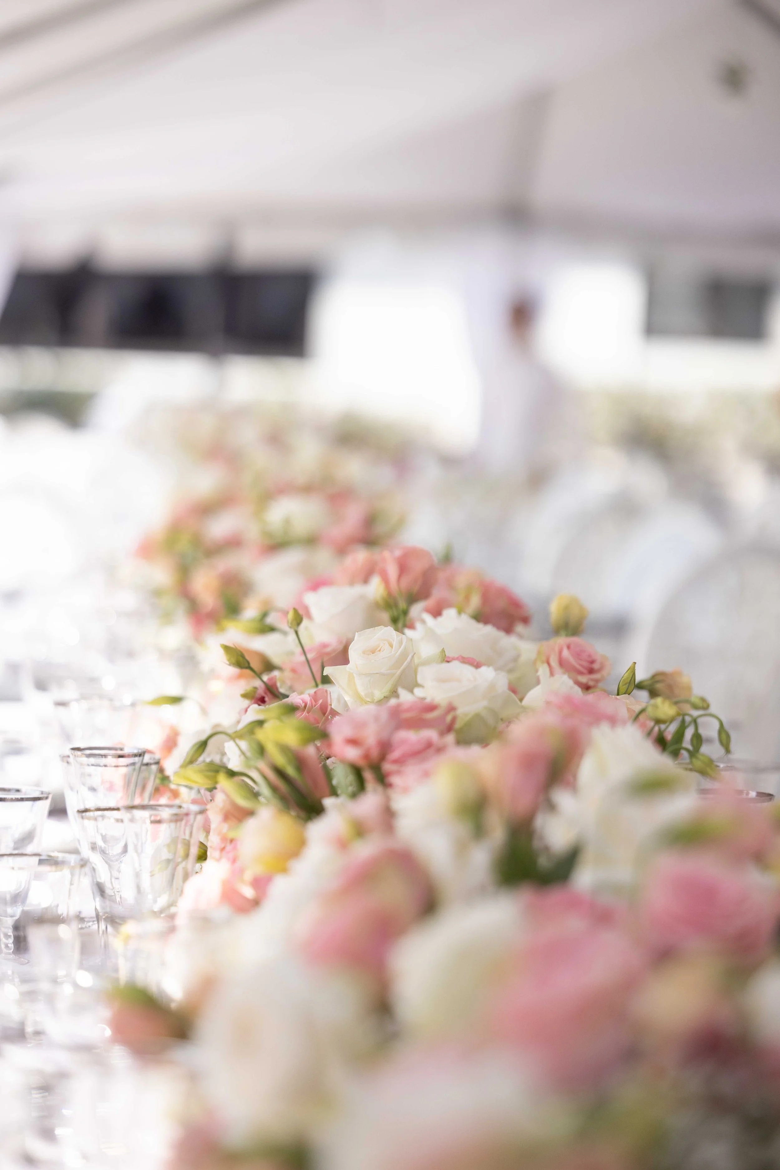 Pink and white rose floral runner on a tented reception table